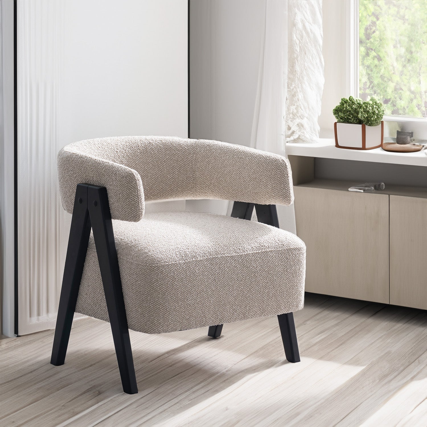 Front view of the Gunnar Accent Chair featuring white bouclé fabric and black A-frame wooden legs.