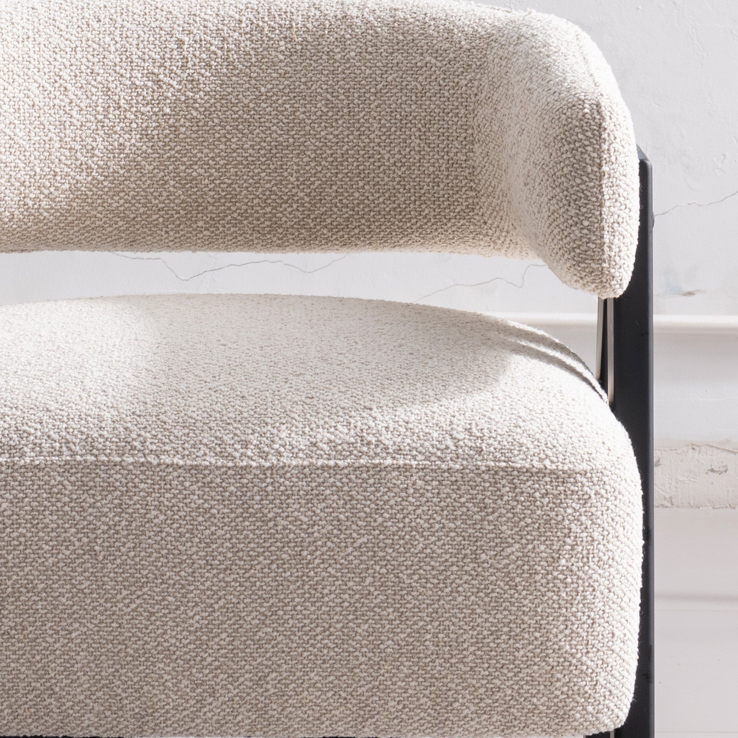 Front view of the Gunnar Accent Chair featuring white bouclé fabric and black A-frame wooden legs.