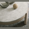 Macro detail shot highlighting the textured grey concrete surface and the organic wood grain of the Guystone table frame