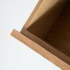 High-angle view into an open drawer showcasing the spacious internal storage and clean wood joinery