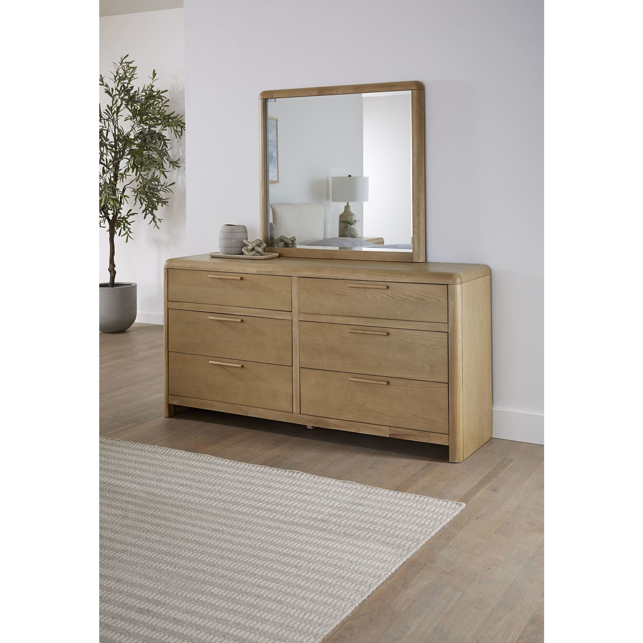 Studio lifestyle shot featuring the Havn dresser and mirror styled with neutral accents in a bright, modern room with light wood flooring