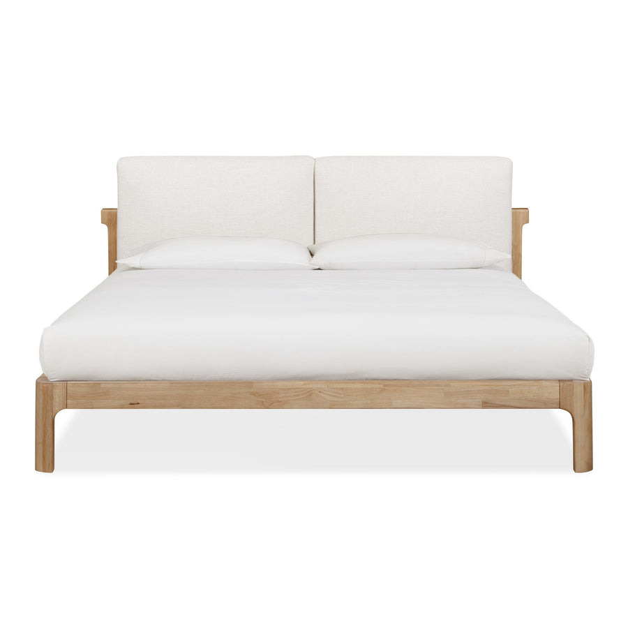 Front view of the Havn platform bed featuring a ginger-finished ash wood frame and a two-cushion natural linen headboard