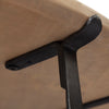 Macro shot highlighting the durable black metal leg construction and hardware connection at the base of the table