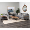 Lifestyle shot featuring the Helios nesting tables styled in a contemporary living room with a grey sofa and neutral rug