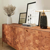 Close-up lifestyle shot of the sideboard top surface styled with minimalist accessories and warm lighting