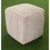 Lifestyle shot of the Highland pouf on a green lawn demonstrating its versatility as casual outdoor or indoor seating