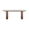 Front view of the Hola oval dining table featuring a light cream ceramic top and two substantial walnut-finished wood pedestal bases