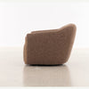 Rear angled view highlighting the seamless coffee brown upholstery and the sturdy wide stance of the chair