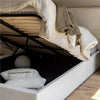 Perspective shot showing the storage compartment open with pillows stored inside to demonstrate capacity