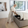 Lifestyle shot showcasing the ease of the hydraulic lift mechanism to access spacious under-bed storage while styled in a modern bedroom