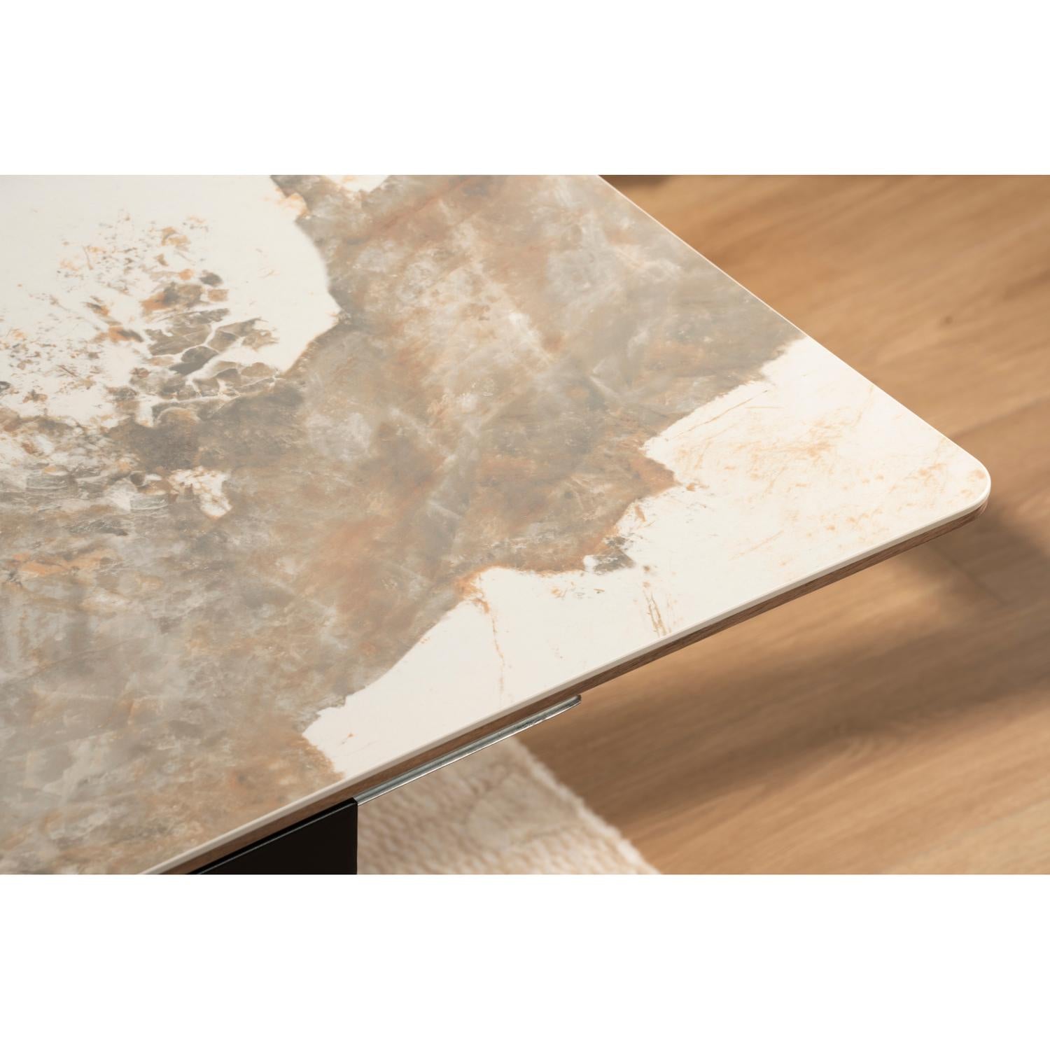 Front view of the Hyld extendable dining table featuring a white patterned ceramic top and a substantial walnut-finished wood pedestal base