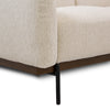 Detail of the Idony Loveseat base showing the wood trim and minimalist black metal legs