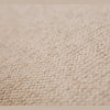 Macro shot of the beige boucle upholstery texture on the Idony Loveseat