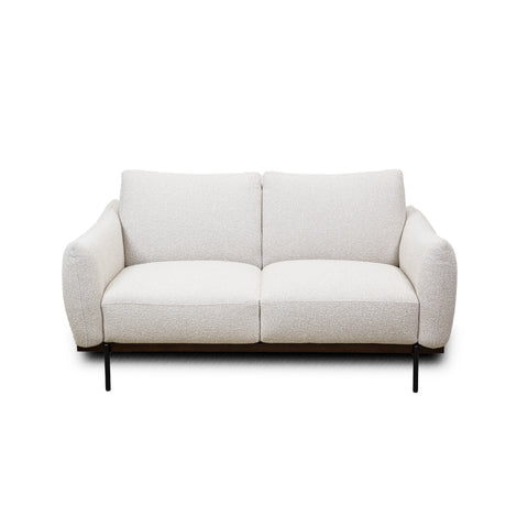 Frontal view of the Idony Loveseat in bright lighting emphasizing its minimalist aesthetic