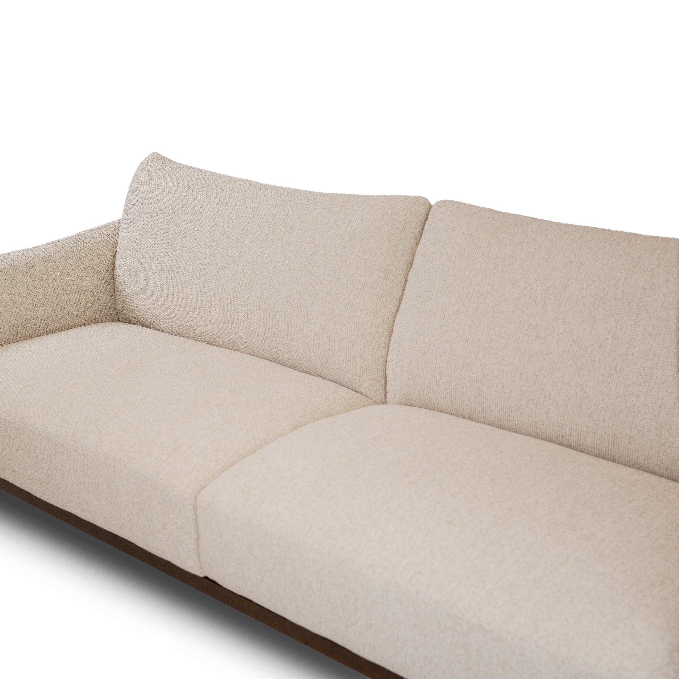 Close-up detail of Idony beige fabric sofa backrest and seat cushions with curved design and wooden base