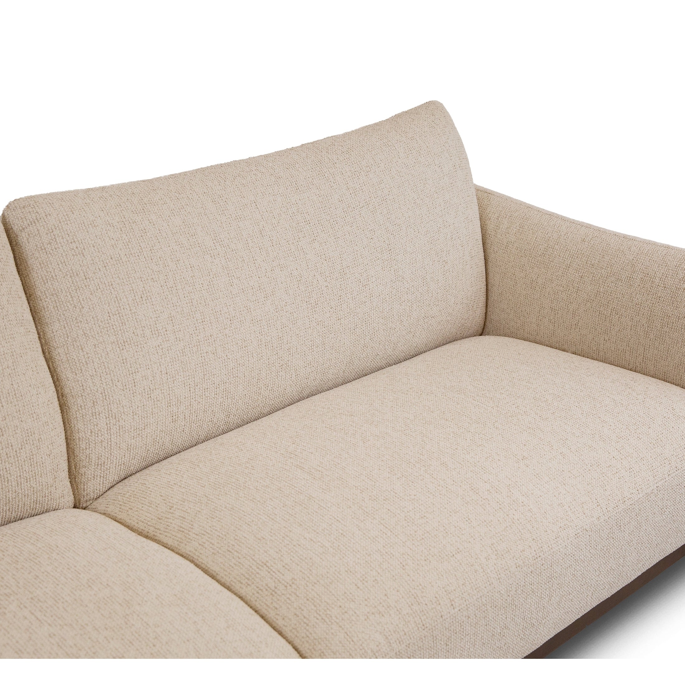 Close-up of Idony sofa in beige textured fabric showing curved backrest and deep seat cushion detail