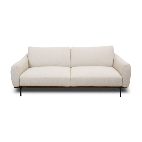 Front view of Idony sofa in beige fabric with curved arms, wooden base, and black metal legs