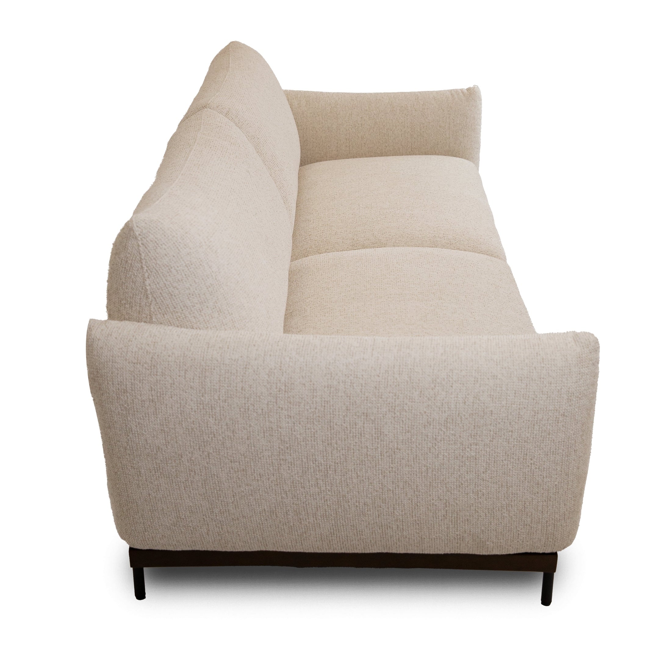 Side view of Idony sofa in beige textured fabric with curved armrest and slim black legs