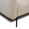 Close-up of Idony sofa corner with beige fabric upholstery, wooden base, and black metal leg