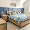 Alternate lifestyle angle showcasing the nightstand and matching dresser against a navy blue paneled wall