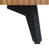 Macro shot focusing on the sturdy black metal tapered leg and its attachment to the bottom of the mango wood frame