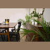 Close-up lifestyle shot of the sideboard surface styled with minimalist ceramic decor in a dining setting