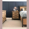 Close-up lifestyle view highlighting the cohesive look of the Irondale nightstand and bed frame in a master suite setting
