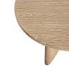 Macro view of the circular tabletop showcasing the natural organic wood grain patterns and smooth light oak finish