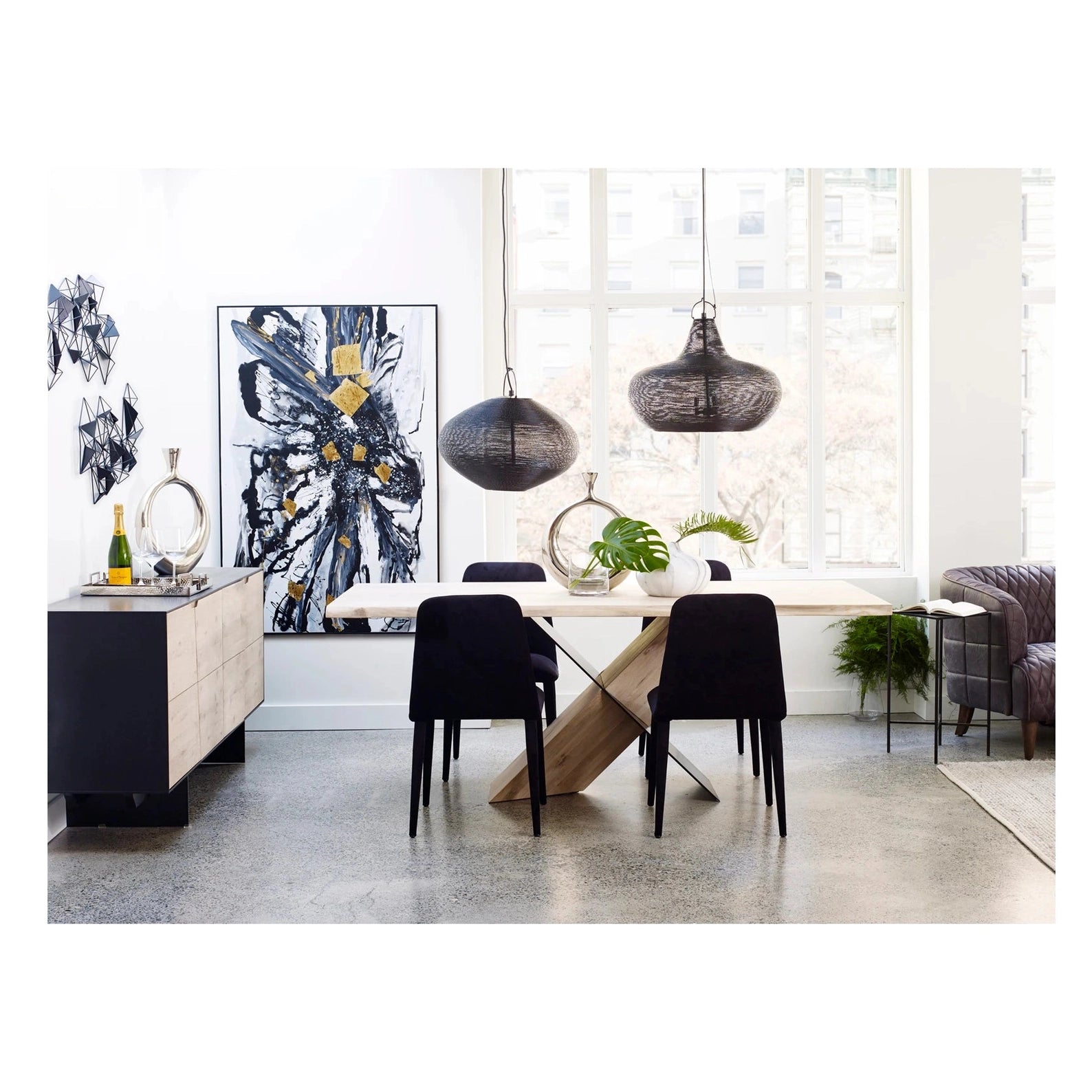 Front view of the Instinct dining table featuring a natural wood top and a sculptural black and oak interlocking X-style base