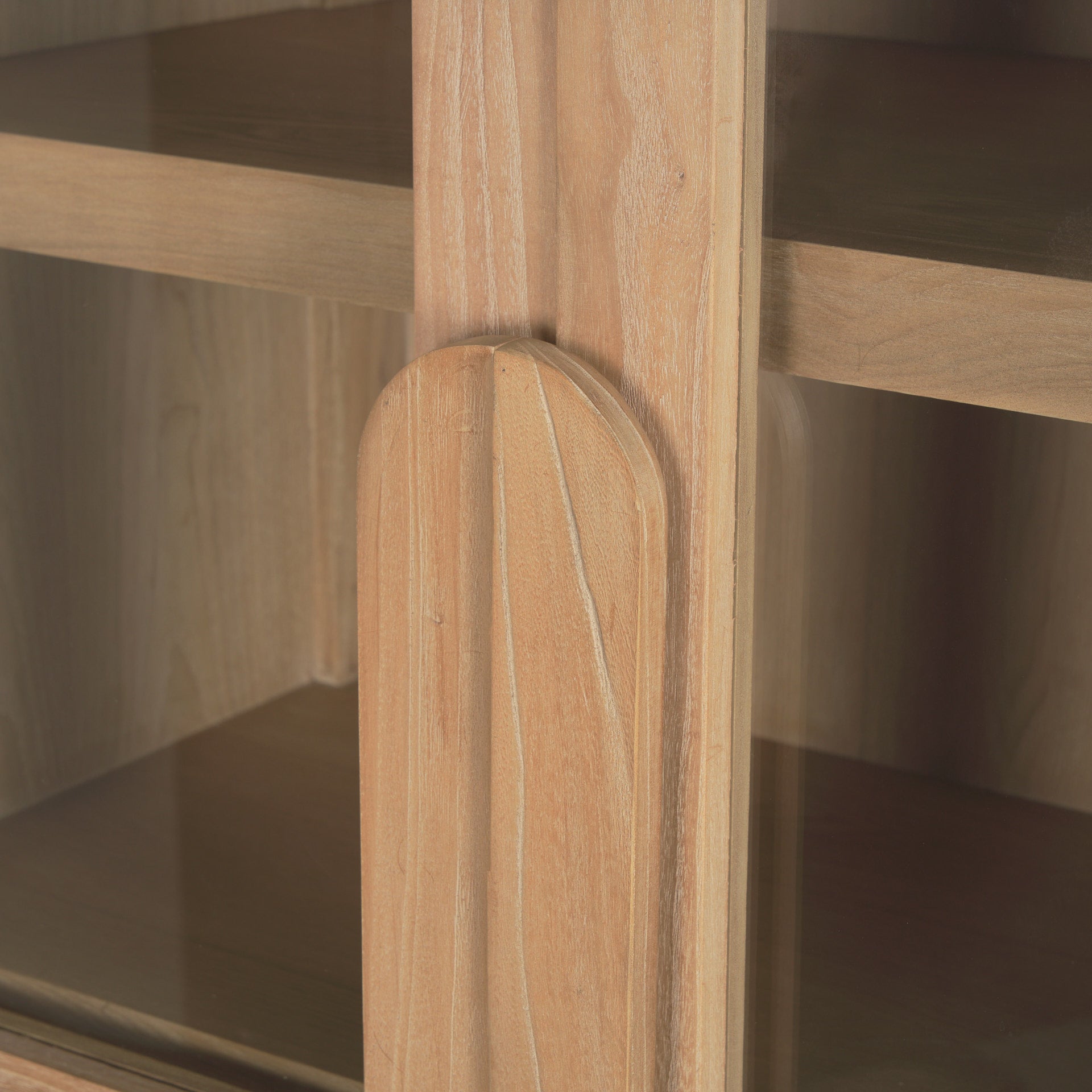 Front view of the Callum arched cabinet featuring light brown elm wood construction and tall glass double doors