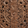 Macro shot focusing on the high-quality hand-carved floral mandala pattern and the natural variegated wood grain