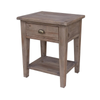 Front perspective view of the Irish Coast side table in a weathered African Dusk grey finish featuring a single drawer and open lower shelf