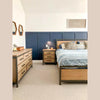 High-angle room perspective highlighting the 7-drawer dresser as part of a cohesive industrial oak bedroom collection
