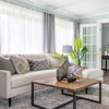 High-angle lifestyle shot of the Irondale table styled with a white sectional sofa and indoor greenery