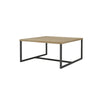 Perspective view highlighting the square silhouette and the sturdy architectural steel base of the coffee table
