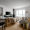 Wide lifestyle view showing the table as a central focal point in a light-filled open-concept living space