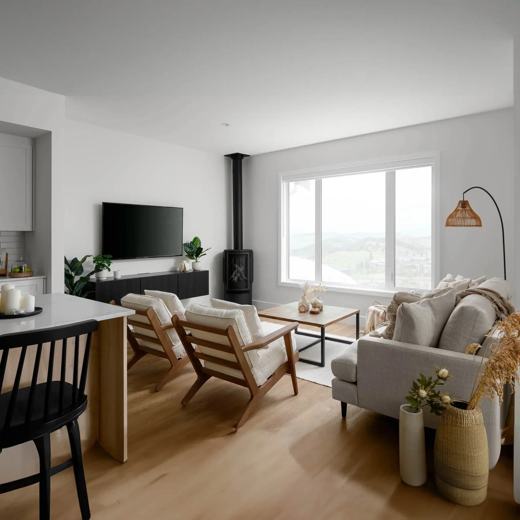 Wide lifestyle view showing the table as a central focal point in a light-filled open-concept living space