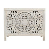 Front view of the Jolie 3-drawer accent chest featuring an intricate hand-carved circular mandala pattern in a distressed white finish