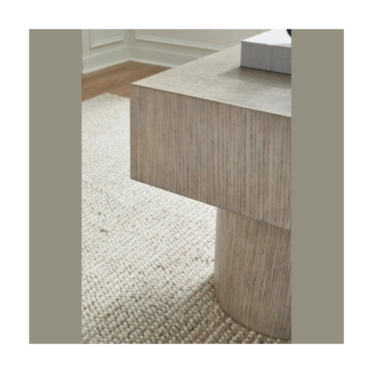Close-up shot focusing on the natural vertical wood grain and the seamless joinery of the grey oak pedestal support