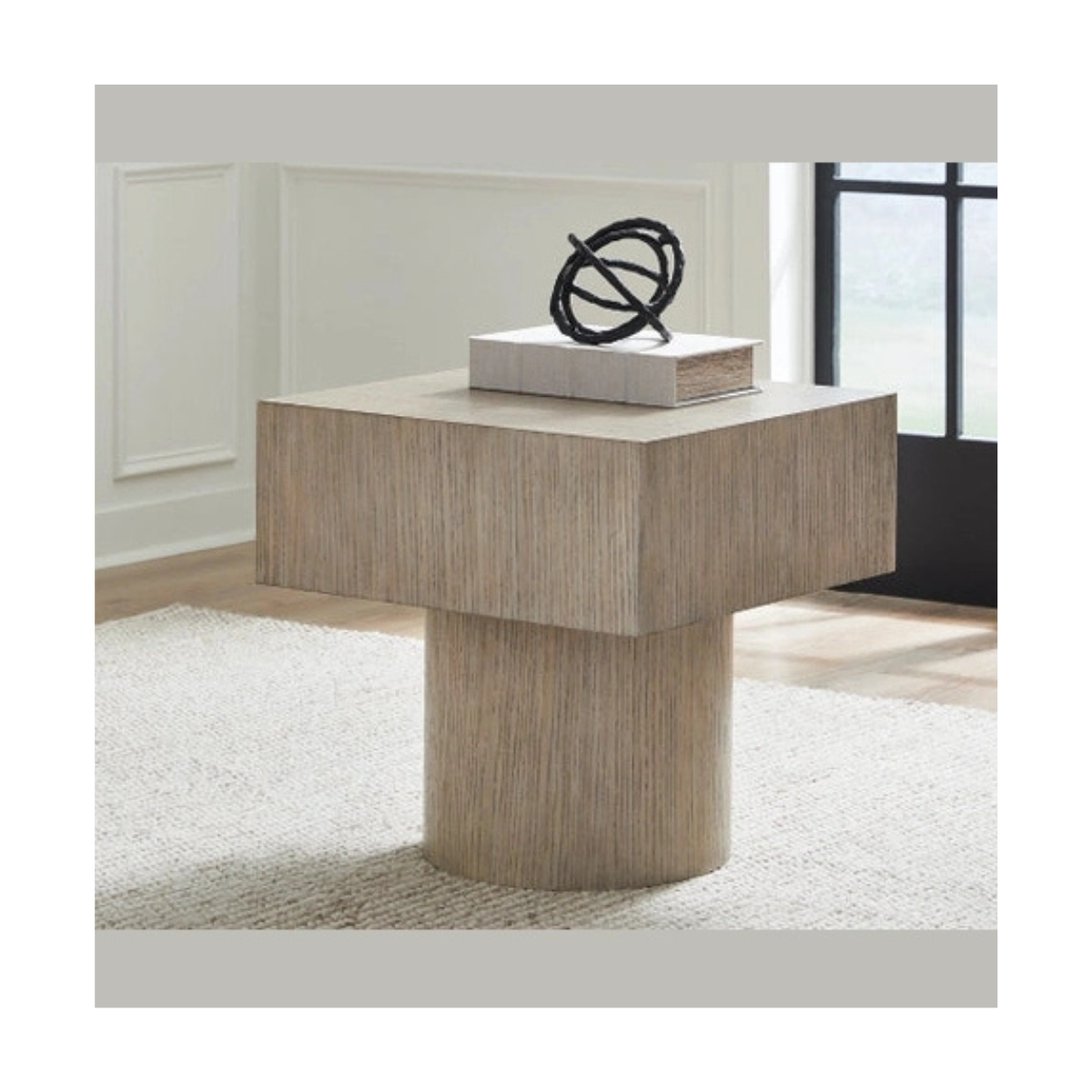 Lifestyle shot of the Jorielyn table styled on a light rug with modern decor to demonstrate scale and interior integration