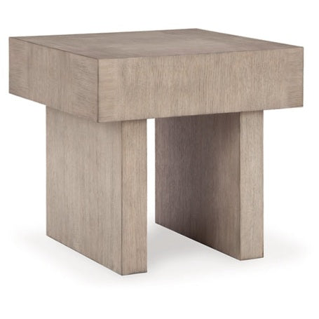 Three-quarter view of the Jorlaina end table featuring a thick square block top on a matching solid recessed pedestal base in a light grey oak finish