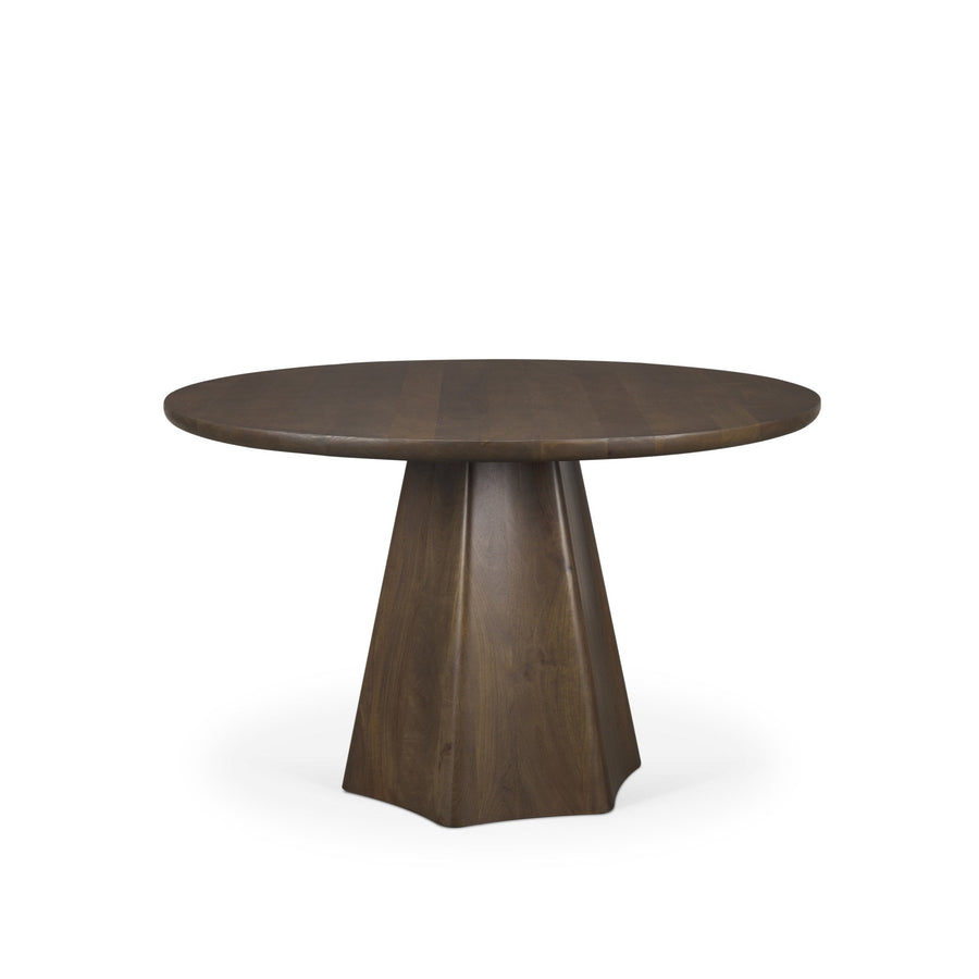 Front view of the Jovani round dining table in a dark mango wood finish featuring a sculptural faceted pedestal base