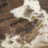 Macro detail shot showcasing the rich brown and cream veining of the natural cappuccino marble tabletop