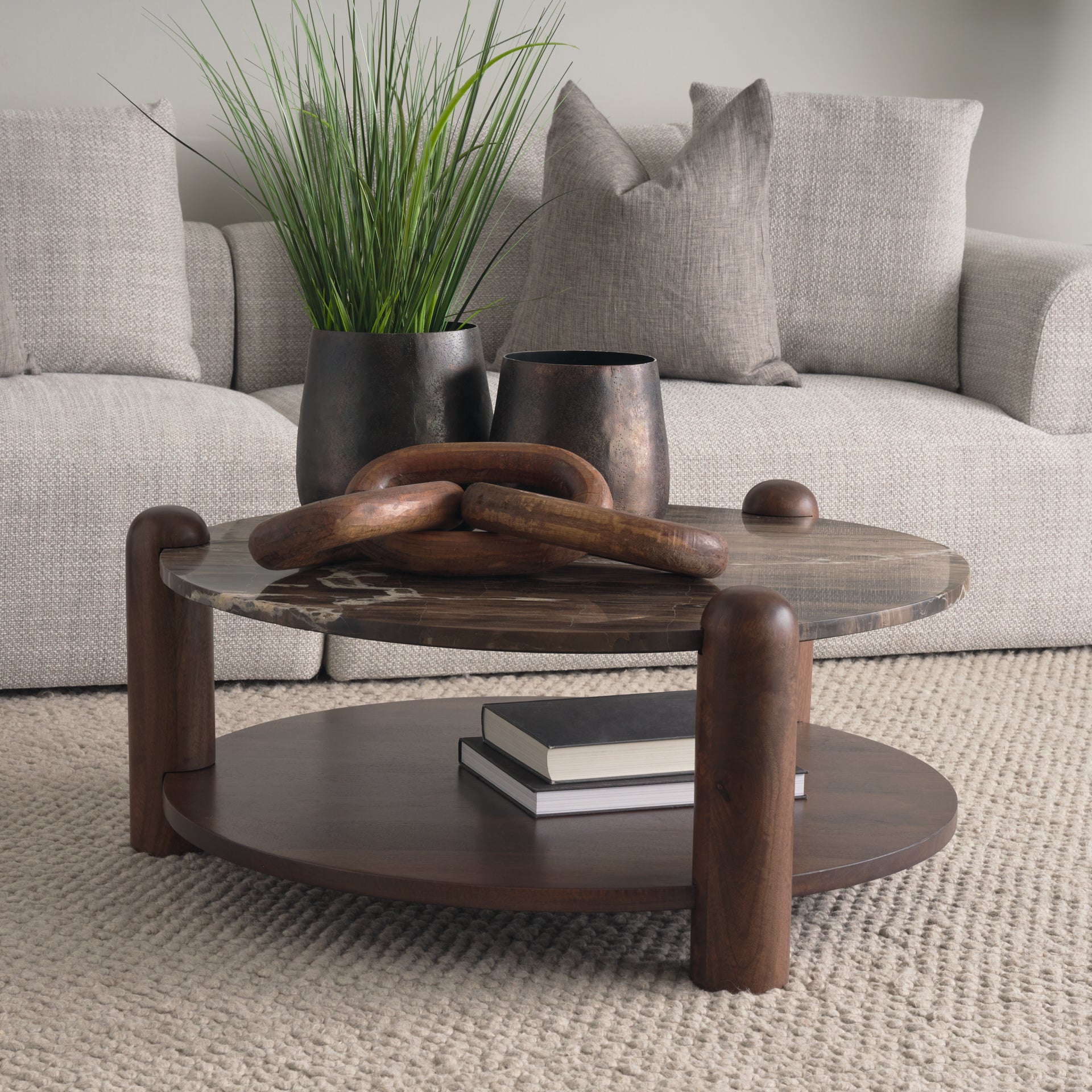 Front view of the Jovia round coffee table featuring a cappuccino marble top and a dark brown mango wood lower shelf