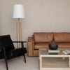 Junior arm chair in black leather in contemporary living room