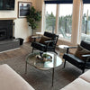 Junior arm chair in black leather in modern interior setting
