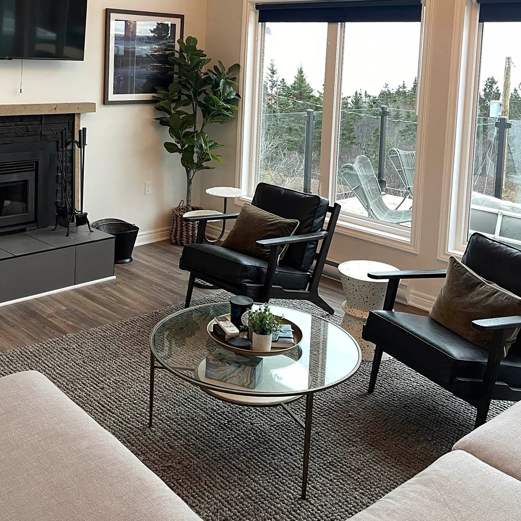 Junior arm chair in black leather in modern interior setting