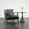 Junior arm chair in black leather in modern interior setting