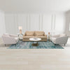 Lifestyle view of the Juno table styled in a formal white living room set between two light grey armchairs with a matching coffee table