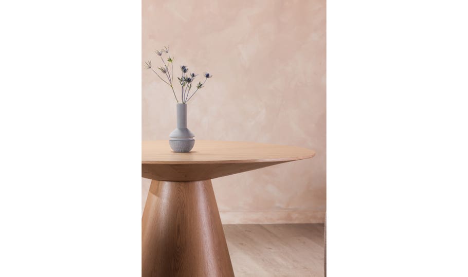 Front view of the 54 inch Otago round dining table in a light natural oak finish with a minimalist conical pedestal base